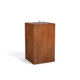 A rectangular corten steel water fountain with a spout on the top edge, displaying a rust-like brown finish.