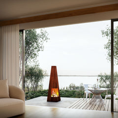 Modern indoor-outdoor living space with Mac Landscape's corten steel fire pit and seating area.