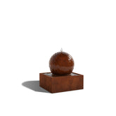 Triton Corten steel ball water feature, water flowing over a 600 mm sphere on a square base