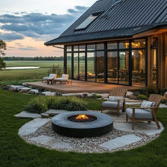 Outdoor patio with fire pit , artificial grass and seating area in front of a modern house.