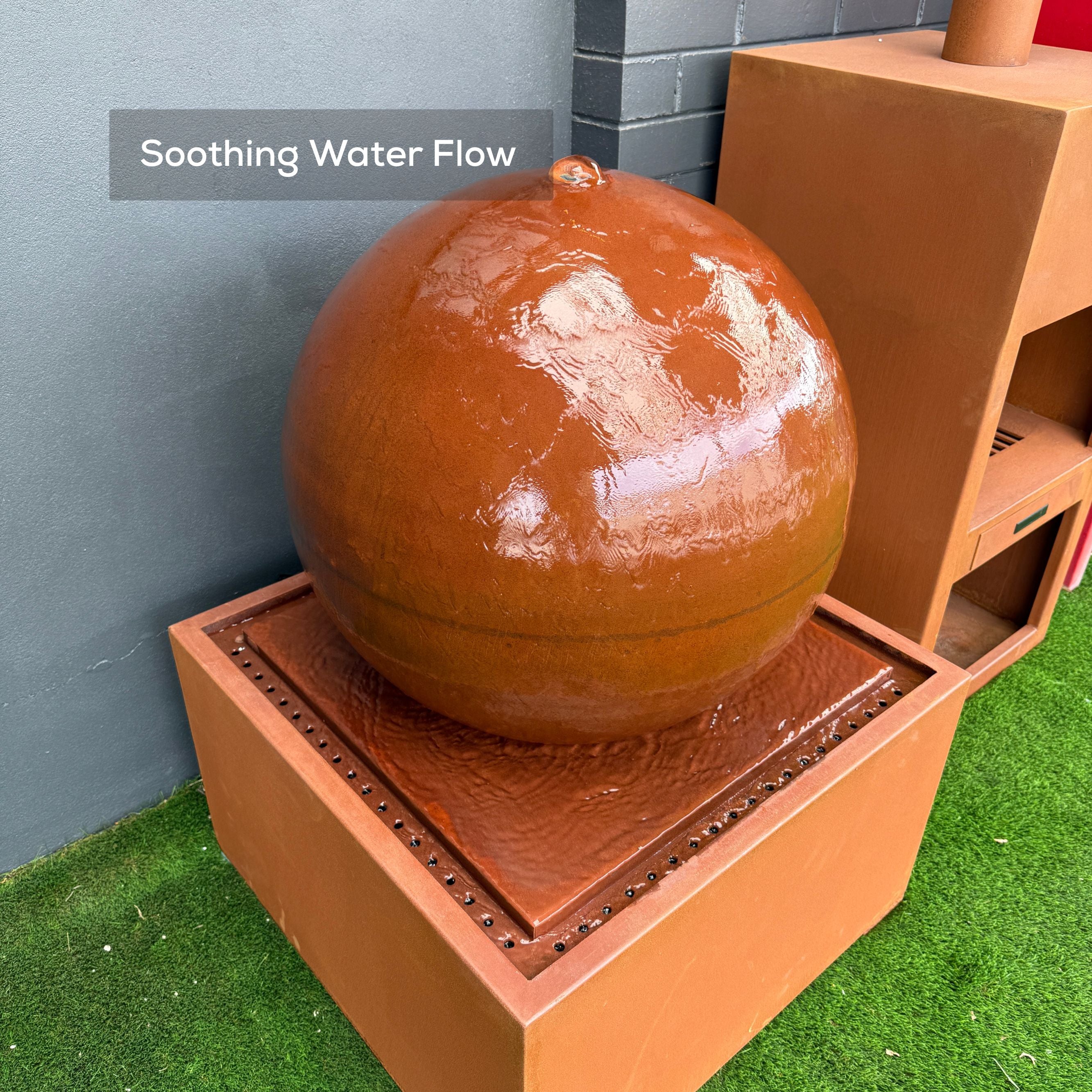 Real Photo of Brown spherical water feature on a grassy area - Mac Landscape