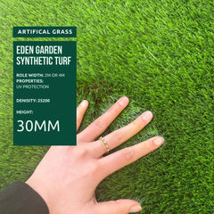 Eden Garden synthetic turf with a hand for scale on a green background