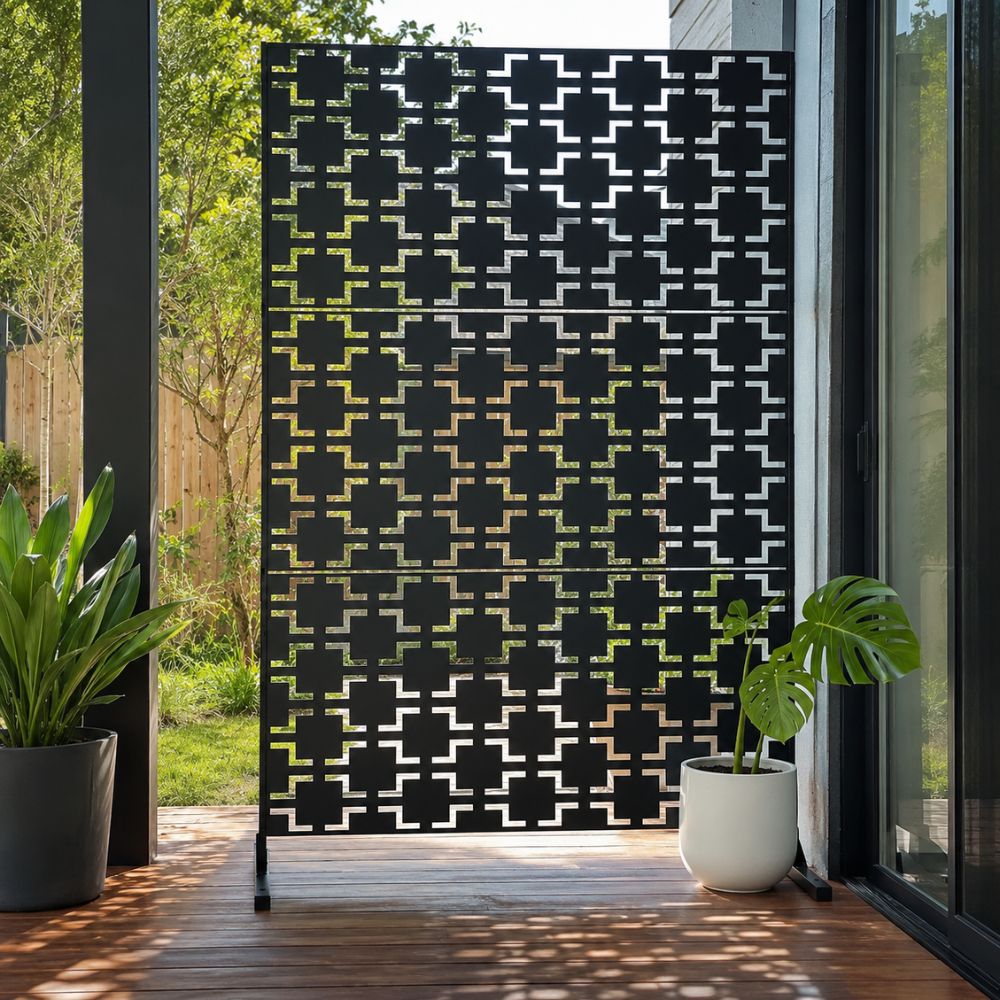 Galvanised Steel Aurelia Screen featuring a modern geometric laser-cut pattern in a black powder-coated galvanised steel panel. Freestanding on a timber deck, the decorative privacy screen enhances a contemporary outdoor living space while providing stylish screening and architectural appeal.