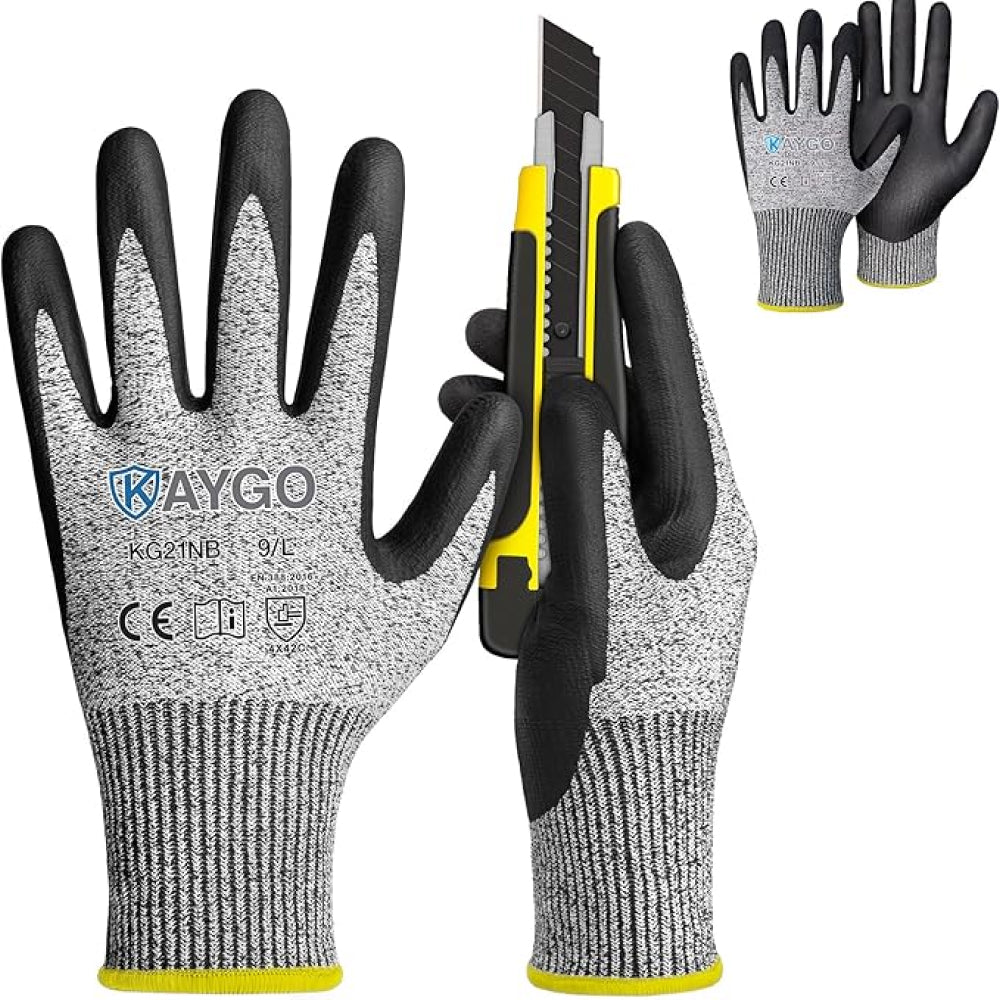A pair of grey and black cut-resistant gloves with a knife on a white background.